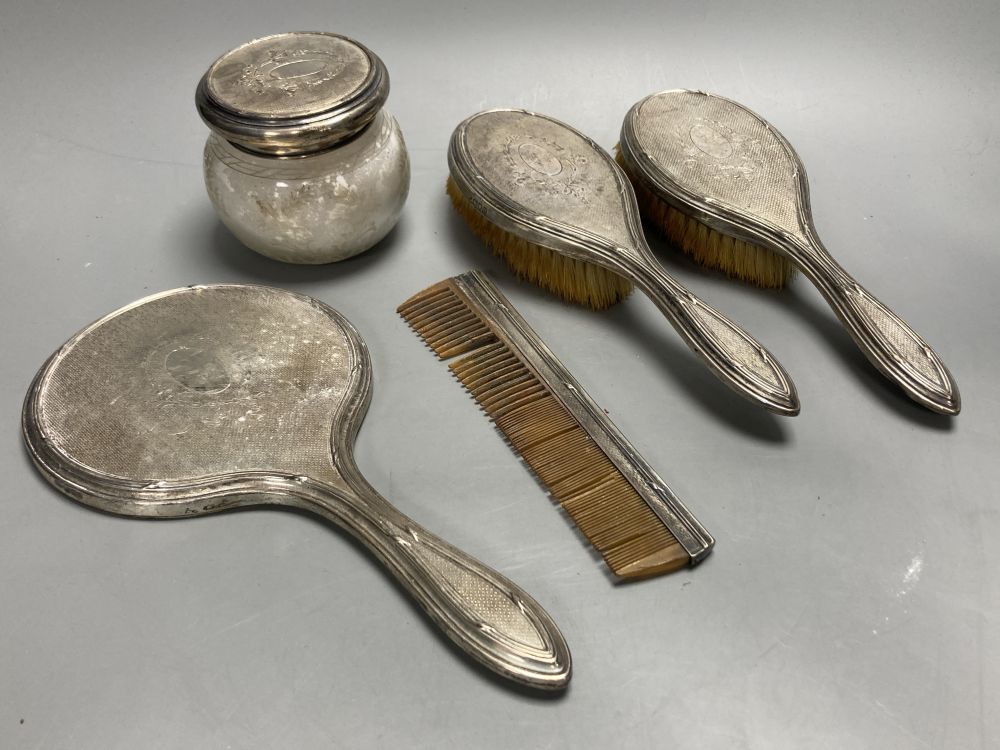 A five-piece silver-mounted dressing table set, London 1919.